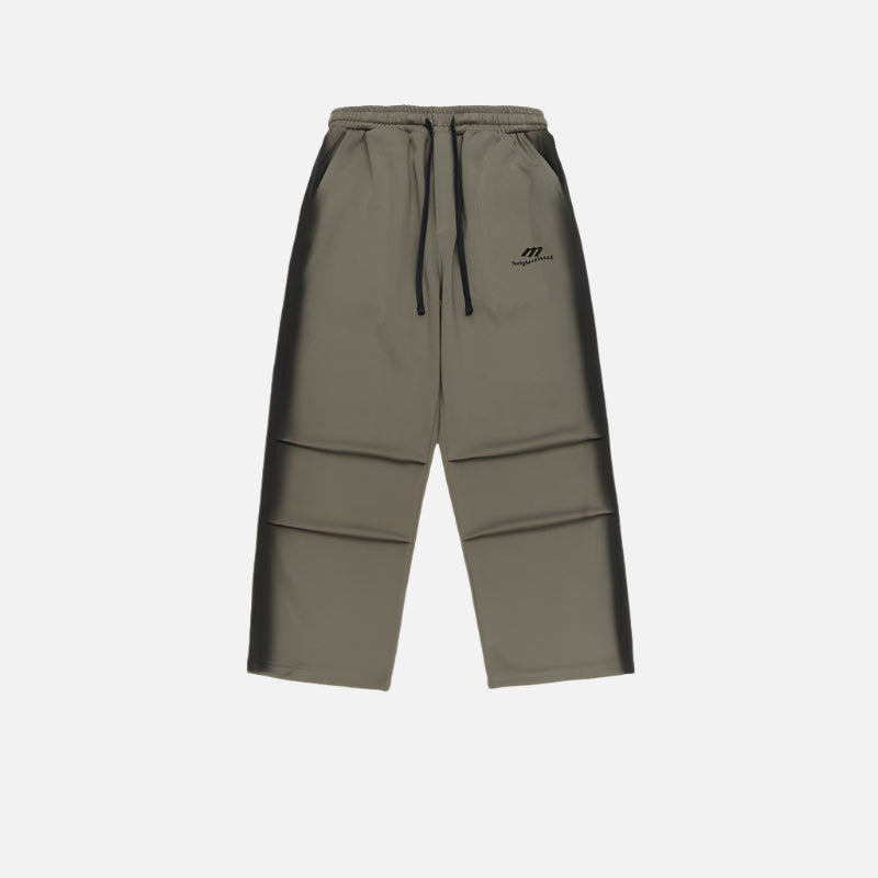 Olive green wide-leg sweatpants with an elastic waistband and black drawstrings, displayed flat against a white background