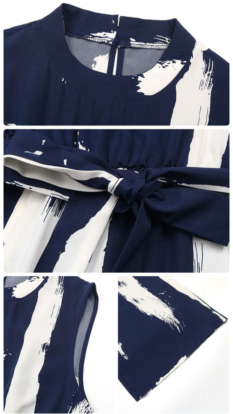 Close-up of the navy jumpsuit showing fabric details, waist tie, and high neckline with a structured collar.