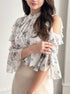 Half-body view of ruffle chiffon blouse in floral print