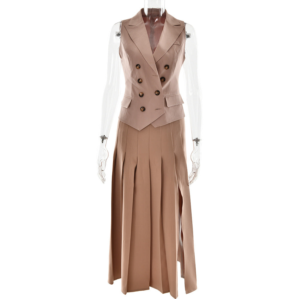 A beige sleeveless double-breasted vest with pleated midi skirt featuring side slit, displayed on transparent mannequin