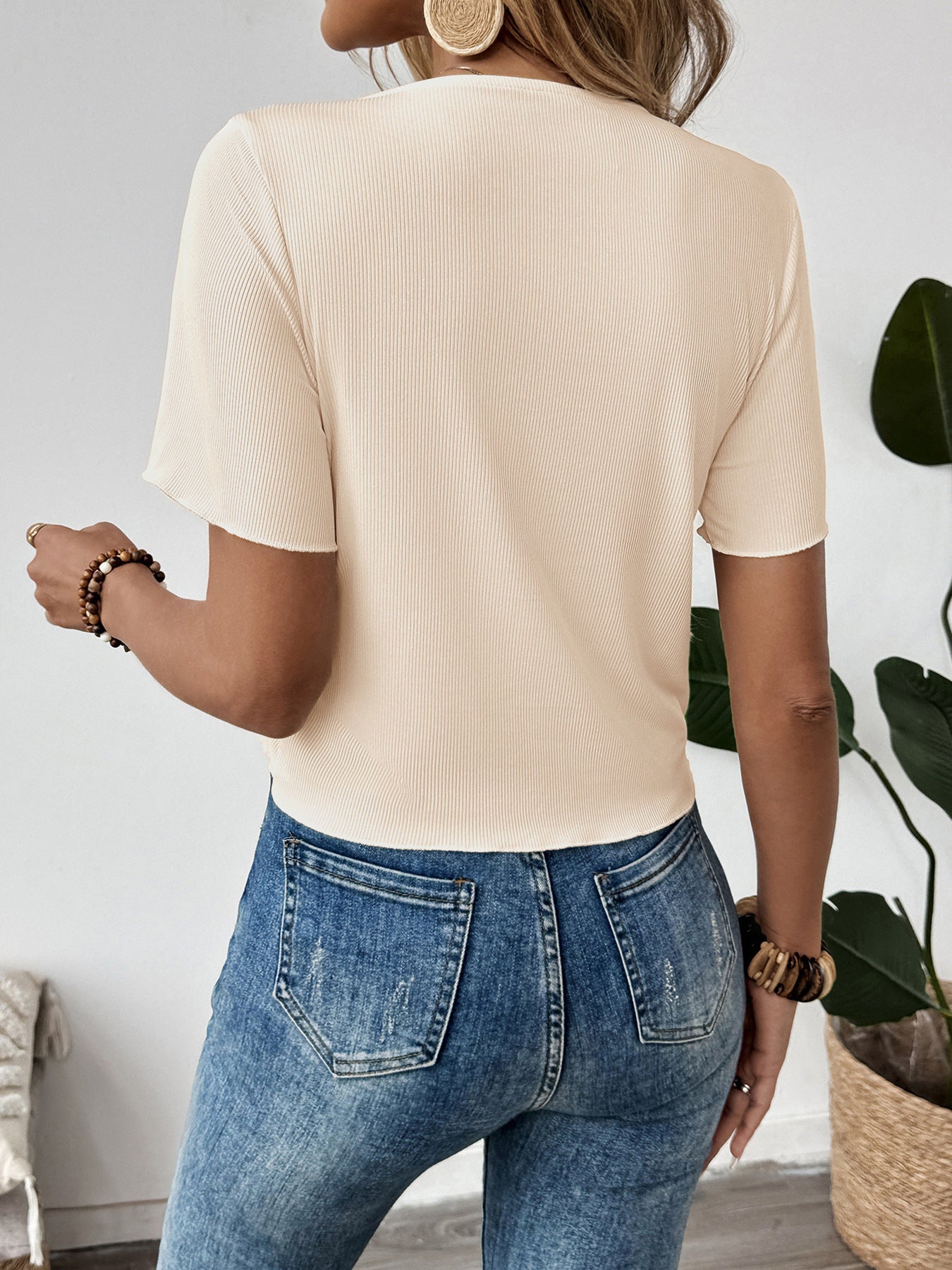 Back view of beige ribbed short sleeve blouse