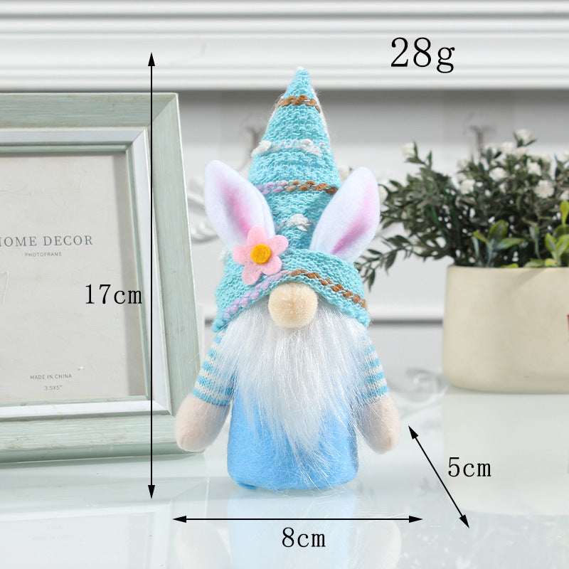 A blue Easter bunny gnome with a knitted hat, glowing body, and soft beard, standing at 17cm with measurement details shown.