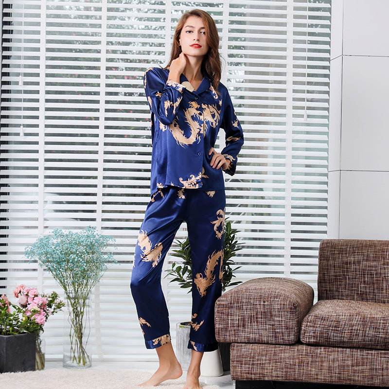 Navy blue silk women's pajama set with golden dragon print, featuring button-up top and tailored pants