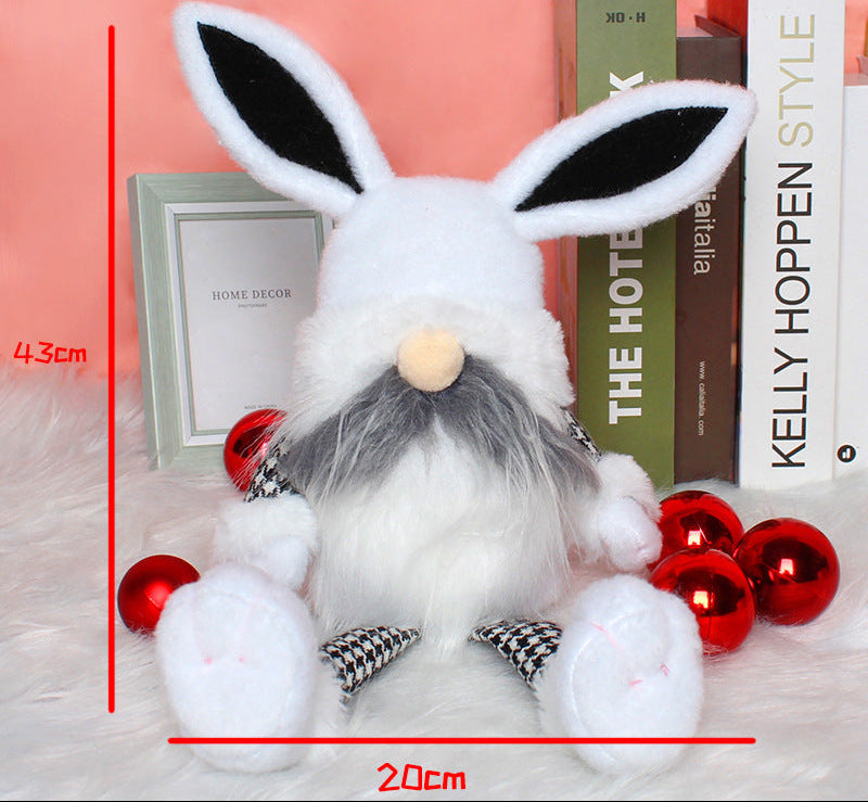 White Easter bunny gnome doll with black ears, fluffy beard, and houndstooth-patterned legs, displayed with size measurements of 43cm height and 20cm width.