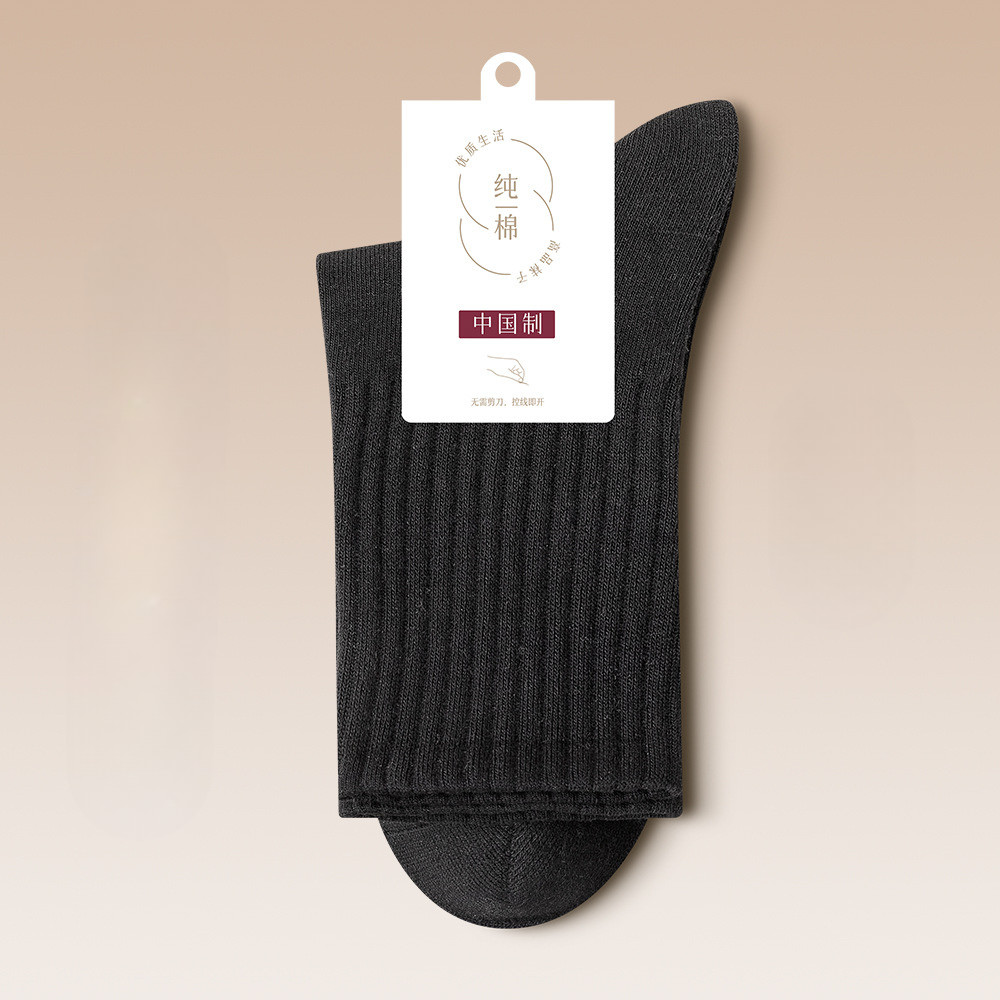 Black ribbed cotton sock with brand tag displaying minimalist packaging design