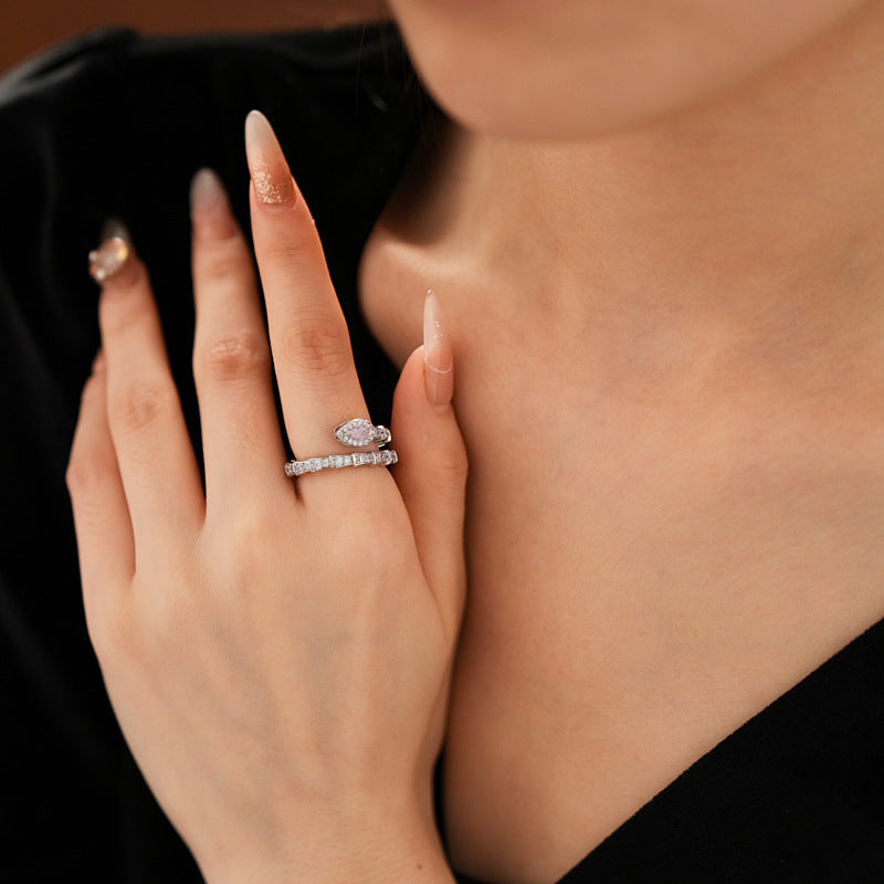 Close-up of intricate snake-inspired diamond ring on elegant hand