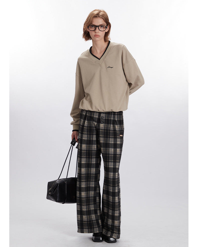 Styled look with beige V-neck sweatshirt and plaid wide-leg pants