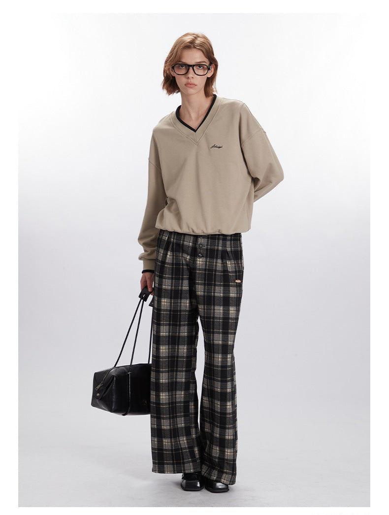 Styled look with beige V-neck sweatshirt and plaid wide-leg pants