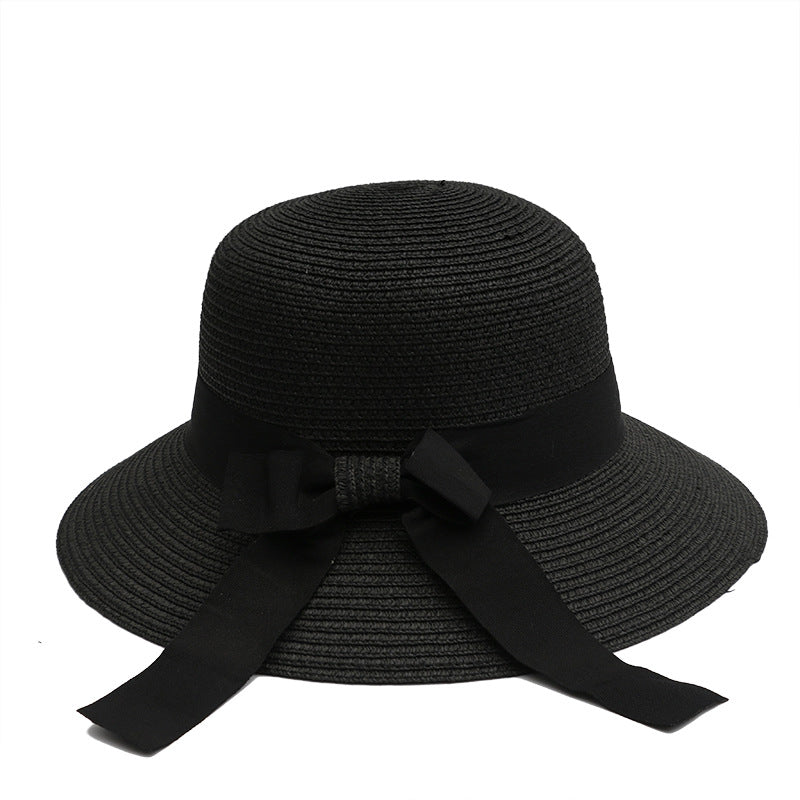 Classic black straw sun hat with a black ribbon bow, designed for stylish sun coverage.