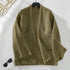 Olive green cardigan on hanger against white background, displaying chunky knit texture and relaxed fit