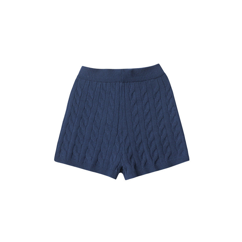 Navy knit shorts with elastic waistband and all-over cable pattern.
