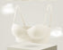 Cream strapless bra with molded cups and a bow detail on the band.