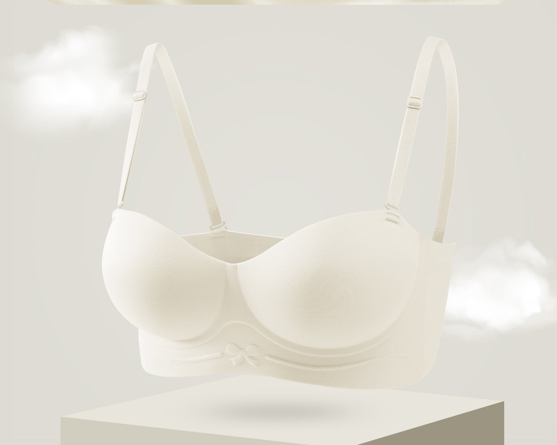 Cream strapless bra with molded cups and a bow detail on the band.