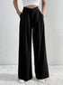 Black wide-leg trousers with V-shaped high waist and pleated front.