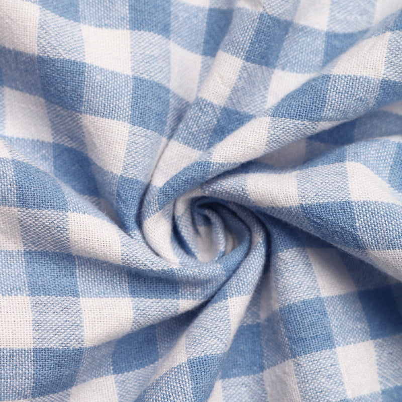Close-up of soft, textured blue and white gingham fabric, showing its lightweight and breathable material.