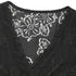 Close-up of black lace blouse's V-neckline, highlighting delicate floral lace and scalloped edges.