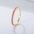 Pink sapphire eternity band in gold setting showcasing vibrant rose-colored stones in prong setting