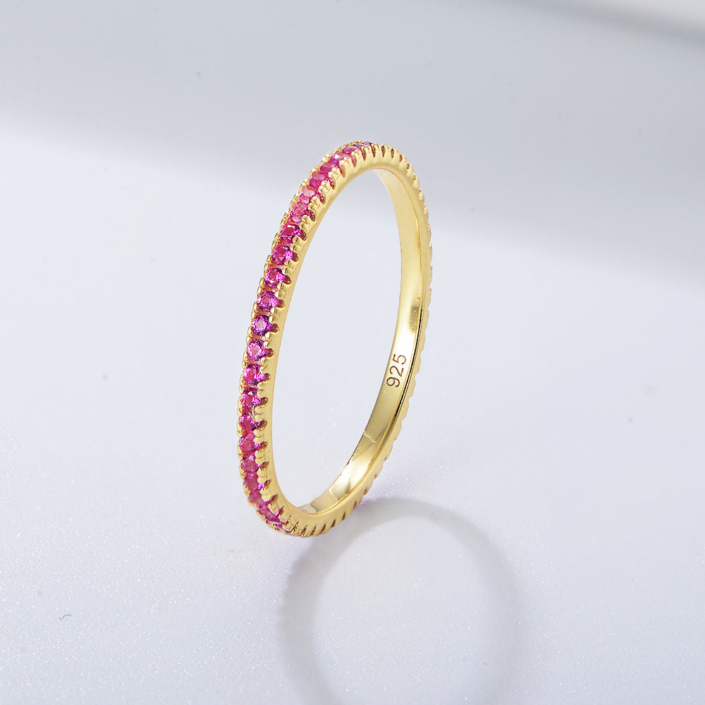 Pink sapphire eternity band in gold setting showcasing vibrant rose-colored stones in prong setting