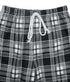 Close-up of black and white plaid fabric showing elastic waistband with a white drawstring detail.
