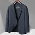 Navy blue textured GFJFRIN blazer on wooden hanger, featuring two-button closure and patch pockets against gray background