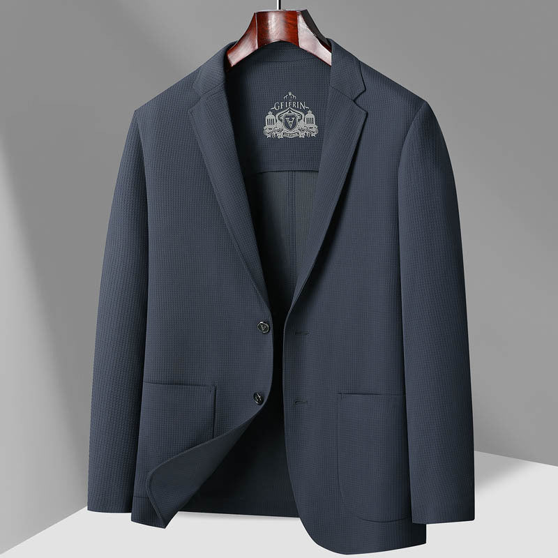 Navy blue textured GFJFRIN blazer on wooden hanger, featuring two-button closure and patch pockets against gray background
