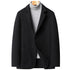 Black wool blazer with notched lapels and two-button closure, styled with a light gray turtleneck sweater on wooden hanger