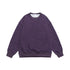 Purple oversized sweatshirt laid flat, featuring an embossed logo on the chest, ribbed cuffs, and a soft washed fabric for a relaxed streetwear fit