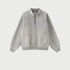 Light gray half-zip pullover with standing collar, brass zipper, ribbed cuffs, heavyweight cotton, minimalist style