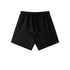 Black cotton lounge shorts with elastic waistband and drawstring ties, photographed flat against white background