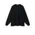 Black oversized long sleeve sweatshirt with crew neck and ribbed cuffs on plain background