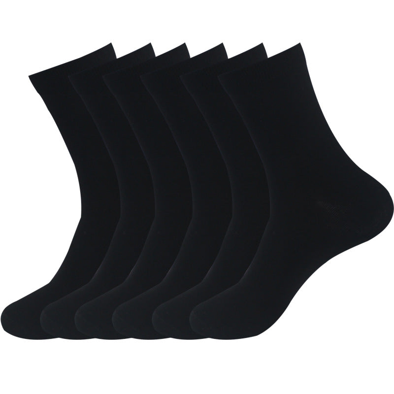 Six black cotton crew socks arranged in a line, showcasing essential sock color