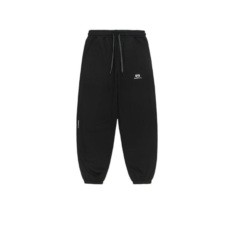 A pair of black jogger sweatpants with an elastic drawstring waist, ribbed cuffs, and a small embroidered logo on the left thigh