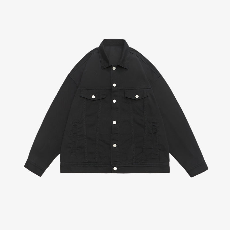 Oversized black denim jacket with silver buttons and traditional chest pocket design displayed against white background