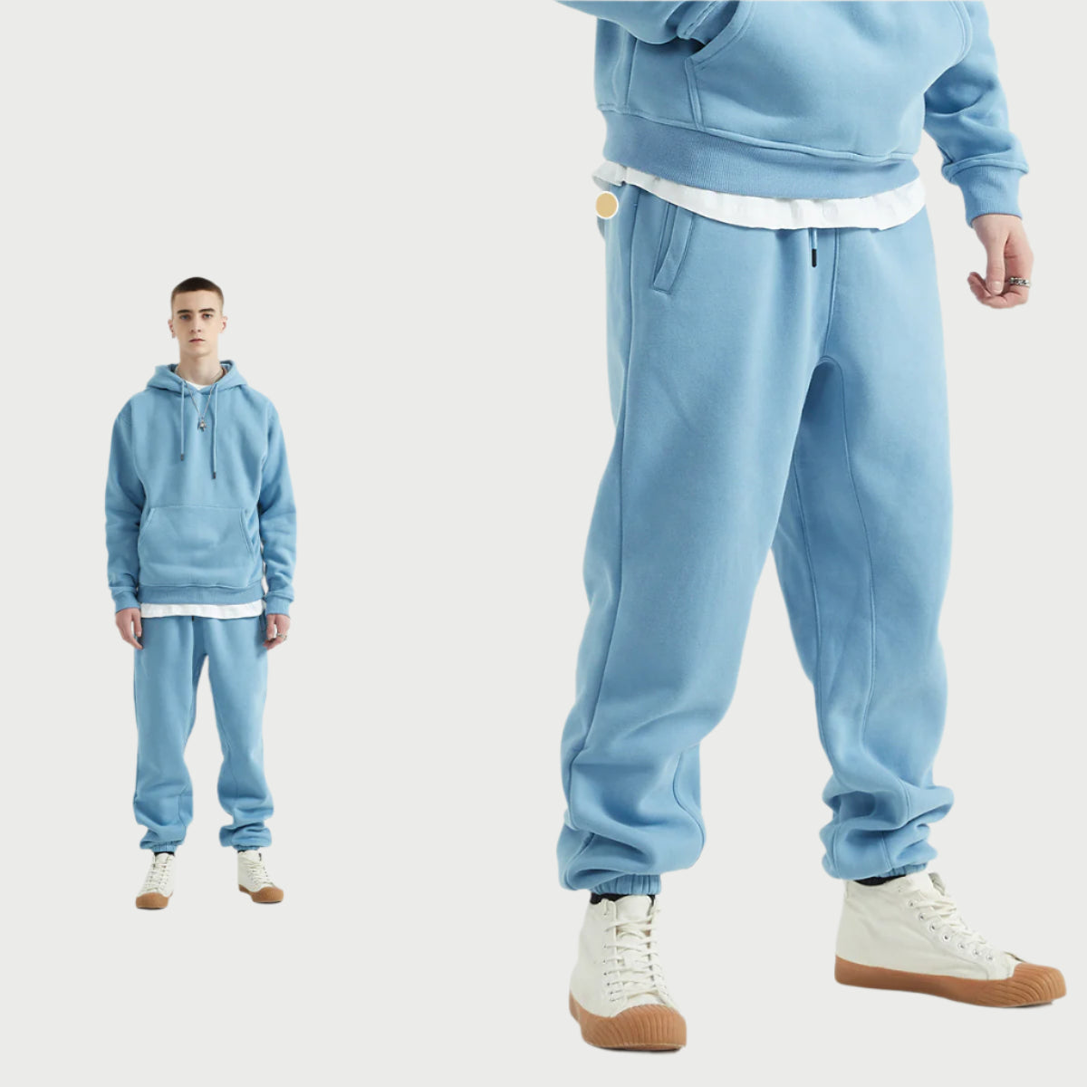 Male model wearing a light blue sweatsuit with hoodie, white undershirt layering, and matching joggers, styled with white high-top sneakers with gum soles