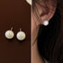 Side-by-side comparison of pearl stud earring worn and product shot showing natural luster