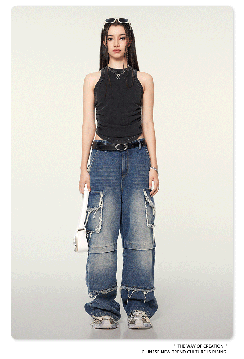 Black fitted tank top with ruched sides shown with distressed jeans