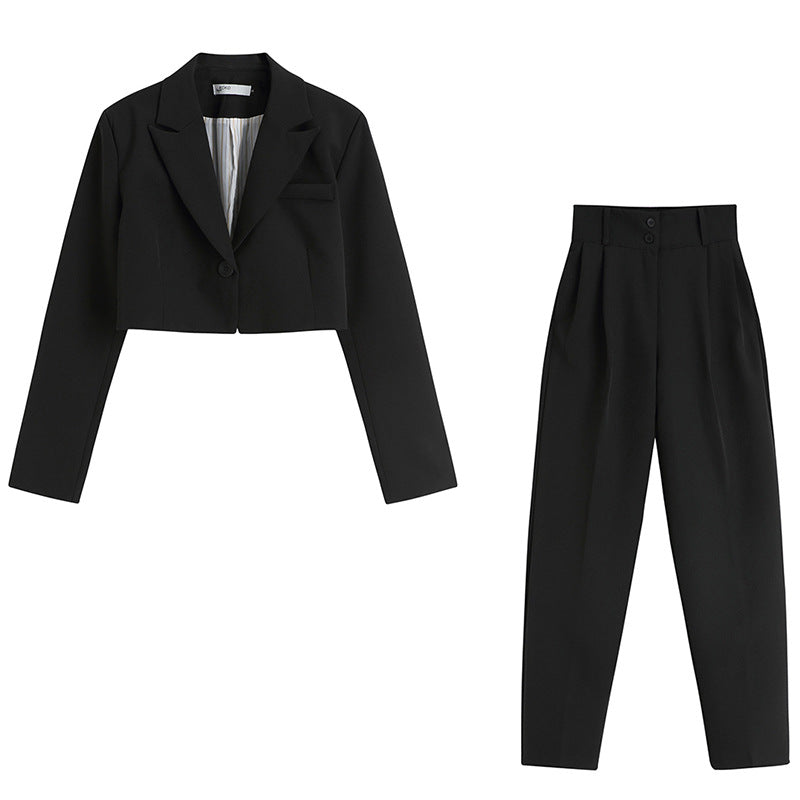 Black two-piece suit set featuring cropped blazer and high-waist pants on white background
