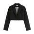 Close-up of black cropped blazer with single button closure and notched lapels