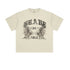 Product shot of cream oversized t-shirt with distressed "BRAVE ABLE" gothic text and tiger graphics against white background