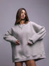 Grey oversized sweatshirt dress – Model wears a relaxed-fit grey sweatshirt dress with silver jewelry for a modern streetwear look