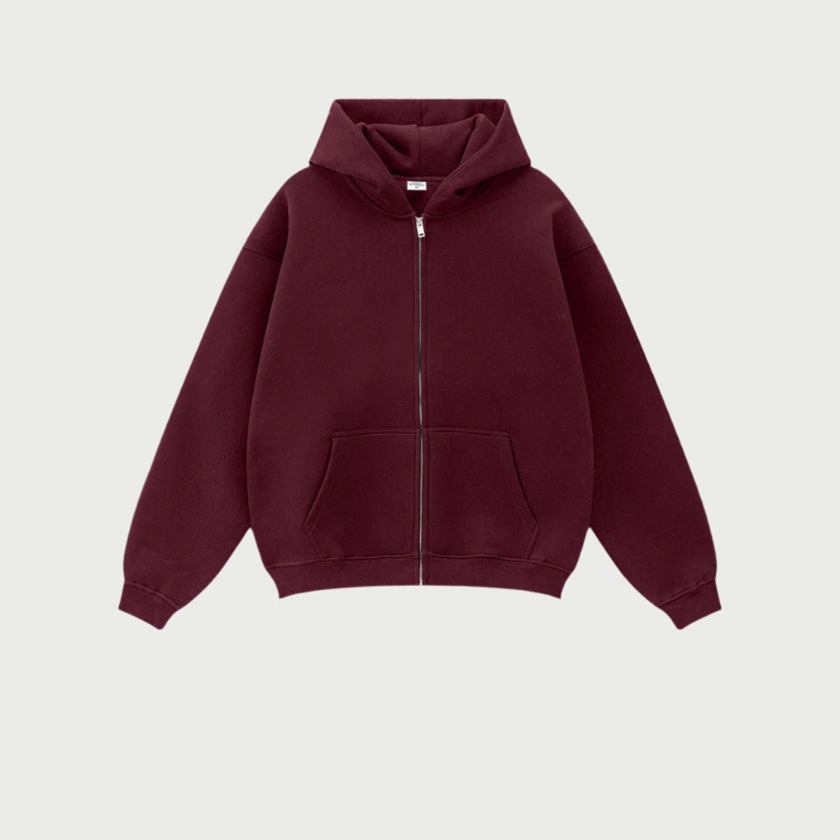 Burgundy oversized zip-up hoodie with front kangaroo pocket and ribbed cuffs displayed on light gray background
