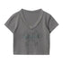 Gray version of the crop top featuring metal grommet neckline and mirror-image abstract print