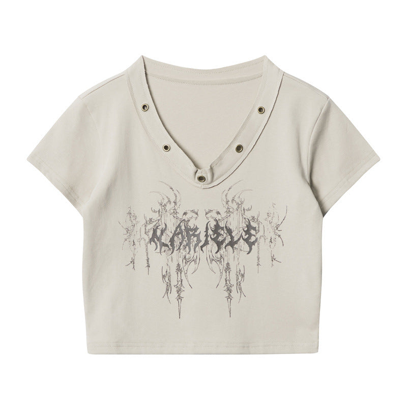 Product photo of beige crop top with V-neck metal grommets and abstract black graphic design