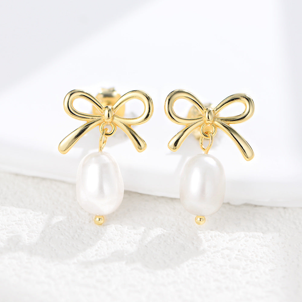 Gold bow stud earrings with pearl drop 925 silver flat lay