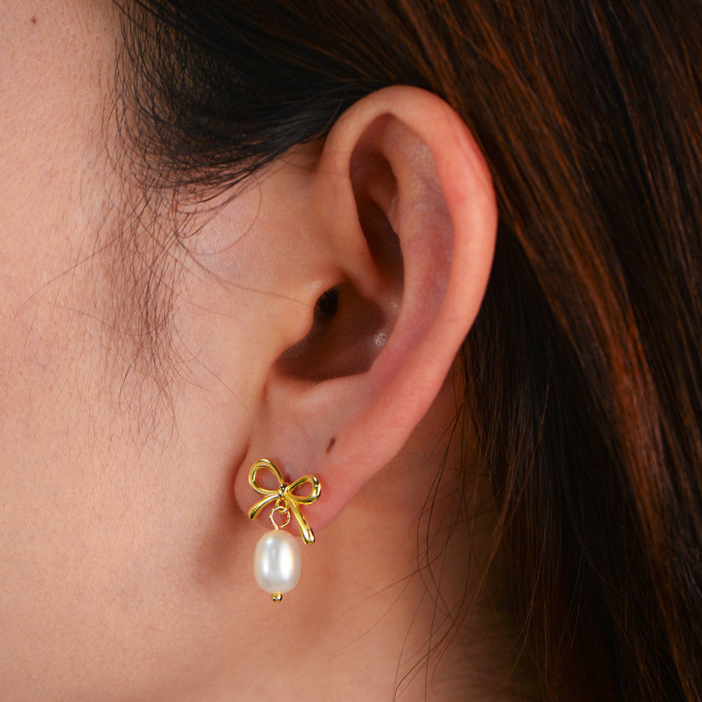 925 silver gold bow pearl earrings front view on ear