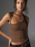 Brown asymmetrical one-shoulder top, showcasing close-up styling details