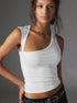 White one-shoulder top with slightly messy updo and hoop earrings