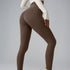 Model wearing taupe athletic leggings and cream top, side pose highlighting fit against gray background