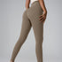 Model in olive taupe leggings and cream top, side view showing seamless design against gray backdrop