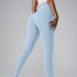 Model wearing off-white high-waisted leggings and matching top, side angle on gray studio background